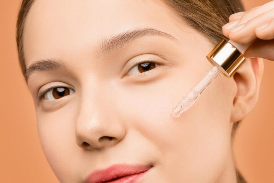 Minimal skincare routine with cleanser, moisturizer, serum, and sunscreen arranged on a clean, neutral background.